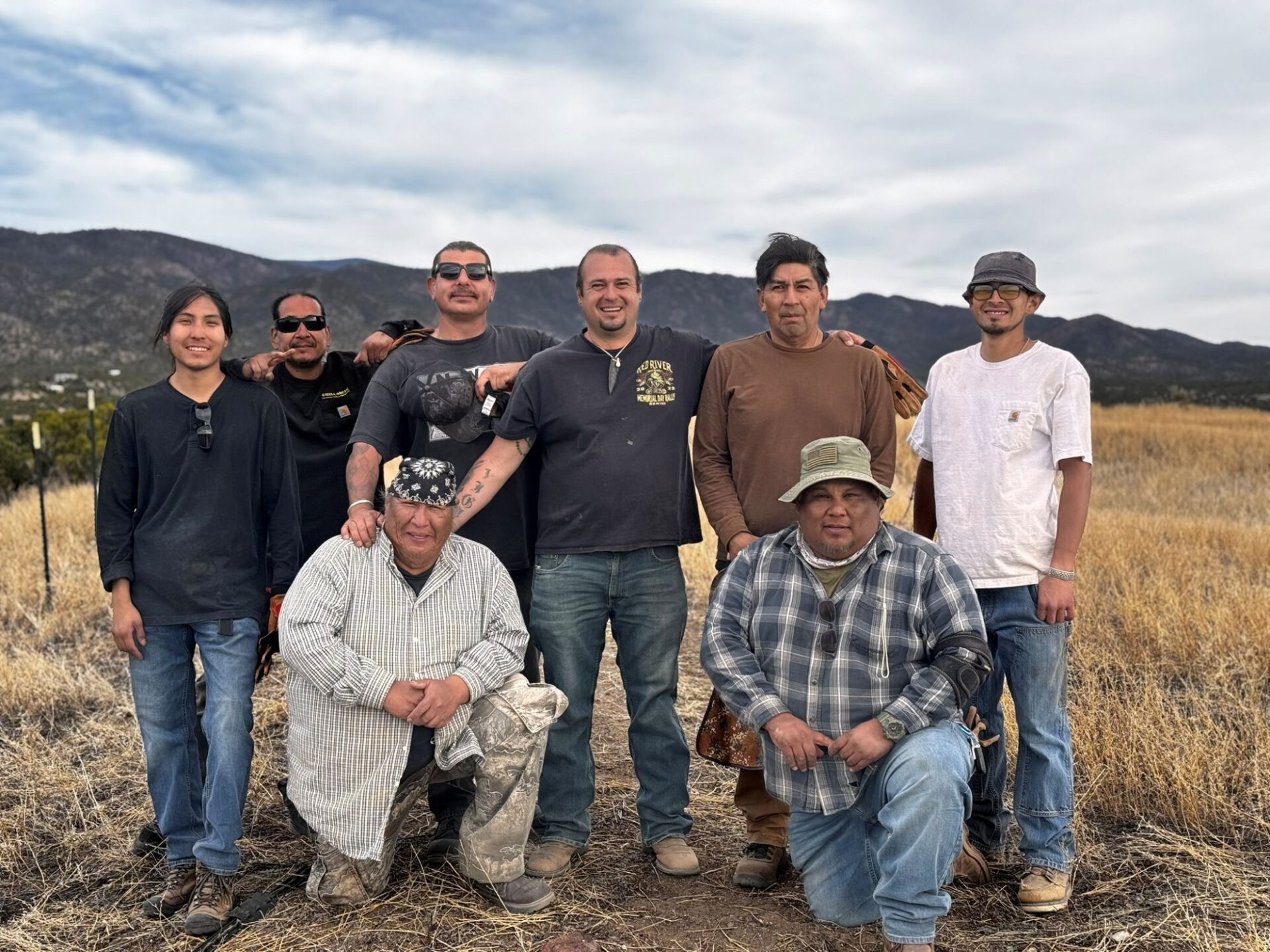 Members of the fencing crew after a long day of installing t-posts at the ancestral Pueblo. From left to right: Jaydin Loretto, Frank Loretto, Kevin Naranjo, Andrew Gonzales, Angelo Walsh, Joe Martin, Franklin Chavez, and William Yates. Image: Sean O’Meara, March 28, 2025